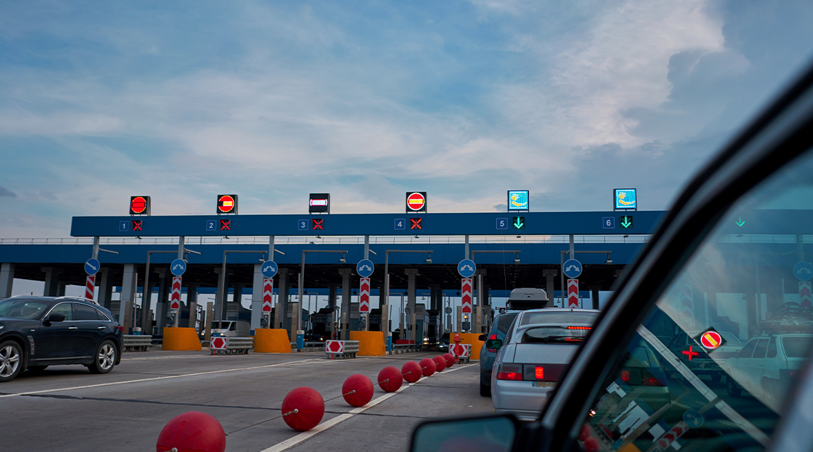 Cars queuing at a motorway toll barrier
